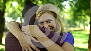 Joyous woman passionately embracing afro-american boyfriend, happy couple