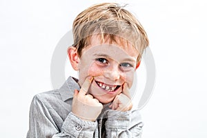 Joyous child  laughing, giggling, playing with a fake toothless smile photo