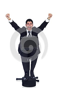 Joyous young business man celebrating with hands raised