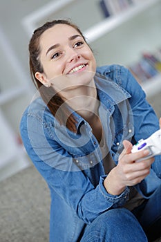 Joyous young woman playing video game