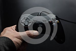 joystick in hand on a black background