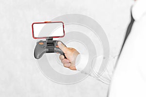 Joystick with a smartphone mockup in the hands of a guy. On a light background