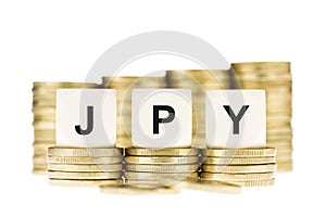 JPY (Japanese Currency) over Gold Coin Stack Isolated on White