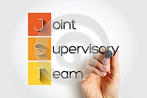 JST - Joint Supervisory Team acronym with marker, concept background