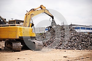 It jsut keeps piling up. a crane at work in a dumpsite.