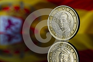 Juan Carlos I King of Spain Euro Coin with Spain Flag Blurred in the Background
