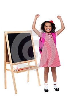 Jubilant little girl in school uniform