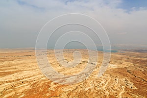 Judaean Desert panorama with wadis and salt lake dead sea seen from Masada fortress, Israel