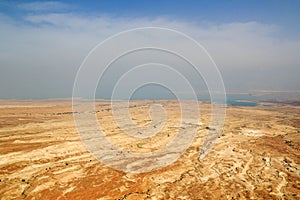 Judaean Desert panorama with wadis and salt lake dead sea seen from Masada fortress, Israel