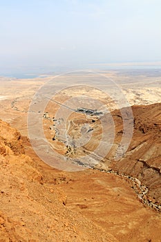 Judaean Desert panorama with wadis and salt lake dead sea seen from Masada fortress, Israel