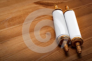 Judaism and religious text concept with a closed Torah on wooden background with copy space photo