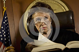 Judge With Book Looking Away In Court Room