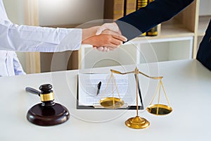 Judge And Client Shaking Hands after agreeing to enter into a contract for a court case In A Courtroom, legal services concept