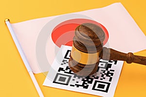 Judge gavel, barcode sheet and the flag of Japan on a yellow background