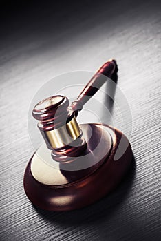 Judge gavel on a black wooden background