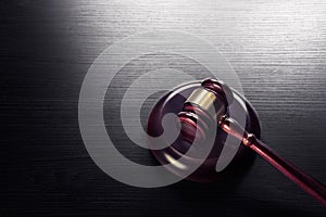 Judge gavel on a black wooden background