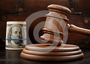 Judge gavel and bundle of hundred-dollar bills