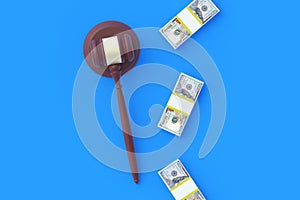Judge gavel and cash on blue background