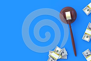 Judge gavel and cash on blue background