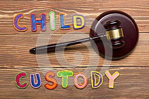 Judge gavel and colourful letters regarding child custody, family law concept.