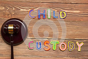 Judge gavel and colourful letters regarding child custody, family law concept.