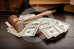 Judge gavel with dollars and law books