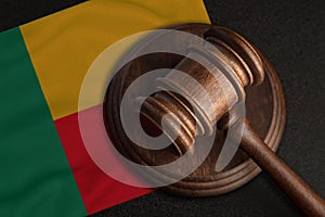 Judge gavel and flag of Benin. Law and justice in Benin. Violation of rights and freedoms