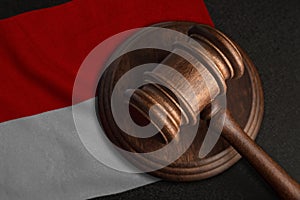 Judge gavel and flag of Indonesia. Law and justice in Indonesia. Violation of rights and freedoms