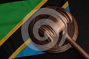 Judge Gavel and flag of Tanzania. Law and justice in United Republic of Tanzania. Violation of rights and freedoms