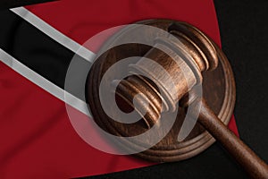 Judge Gavel and flag of Trinidad and Tobago. Law and justice in Republic of Trinidad and Tobago. Violation of rights and freedoms