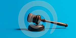 a judge gavel in front of a light blue screen
