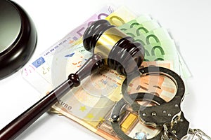Judge gavel, handcuffs and money