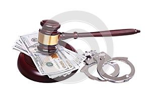 Judge gavel and handcuffs with money isolated on white