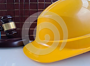 Judge gavel and hard hat book with symbol of trial and sentences