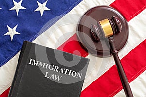 Judge gavel and Immigration Law book on United States of America flag