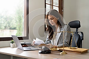 Judge gavel with Justice lawyers, Business woam in suit or lawyer working on laptop and documents. Legal law, advice and
