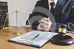 Judge gavel with Justice lawyers, counselor in suit or lawyer working on a documents at law firm in office. Legal law, advice and