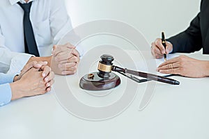 Judge gavel with Justice lawyers deciding, consultation on marriage divorce between married couple and signing divorce documents photo