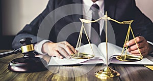 Judge gavel with Justice lawyers, Gavel on wooden table and Counselor or Male lawyer working on a documents at law firm in office