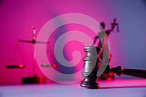 Judge gavel, lady justice and scales on purple background