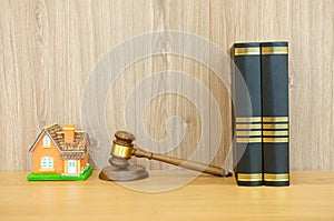 judge gavel law book & house model on wooden desk. real estate d