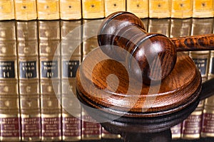 Judge gavel with law books in the background