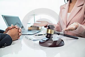 judge gavel in law office is placed on table to symbolize judge deciding lawsuit. gavel wood on wooden table of lawyers in lega photo