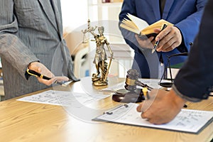 judge gavel in law office is placed on table to symbolize judge deciding lawsuit. gavel wood on wooden table of lawyers in lega photo