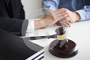 Judge gavel with lawyers advice legal at law firm in background.