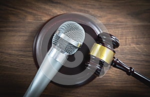 Judge gavel and microphone on the wooden table. Concept of Auction