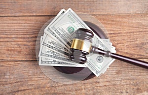 Judge gavel and money on brown wooden table