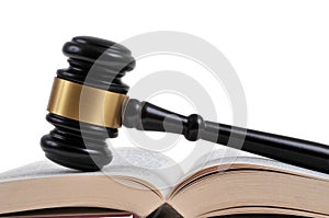 Judge gavel on open book close up on white background