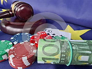 Judge gavel with poker chips playing cards on flag of European Union