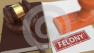 Judge gavel and red FELONY stamp on the paper. Court related 3d rendering